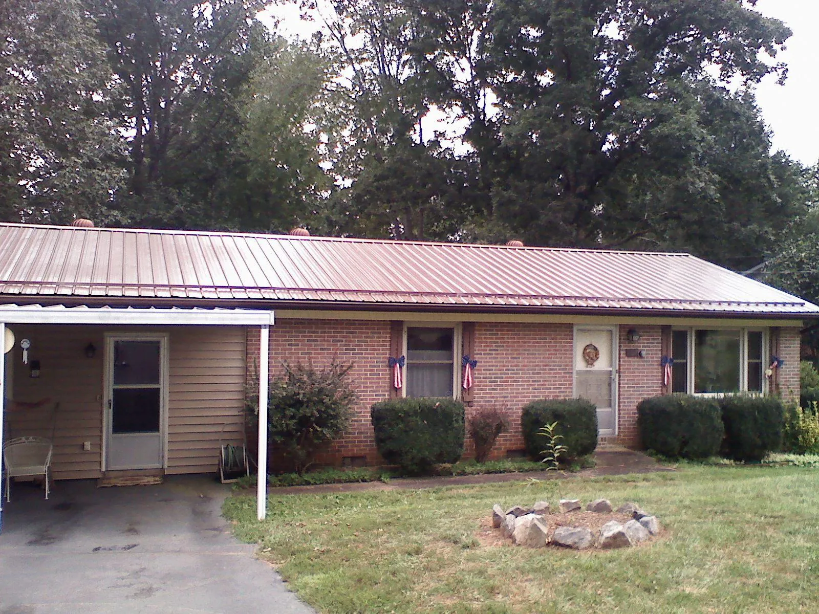 Bronze metal roof and carport on a brick ranch home — Roof Repair work by our crew in Cle Elum